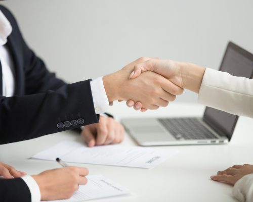 hr-handshaking-successful-candidate-getting-hired-new-job-closeup